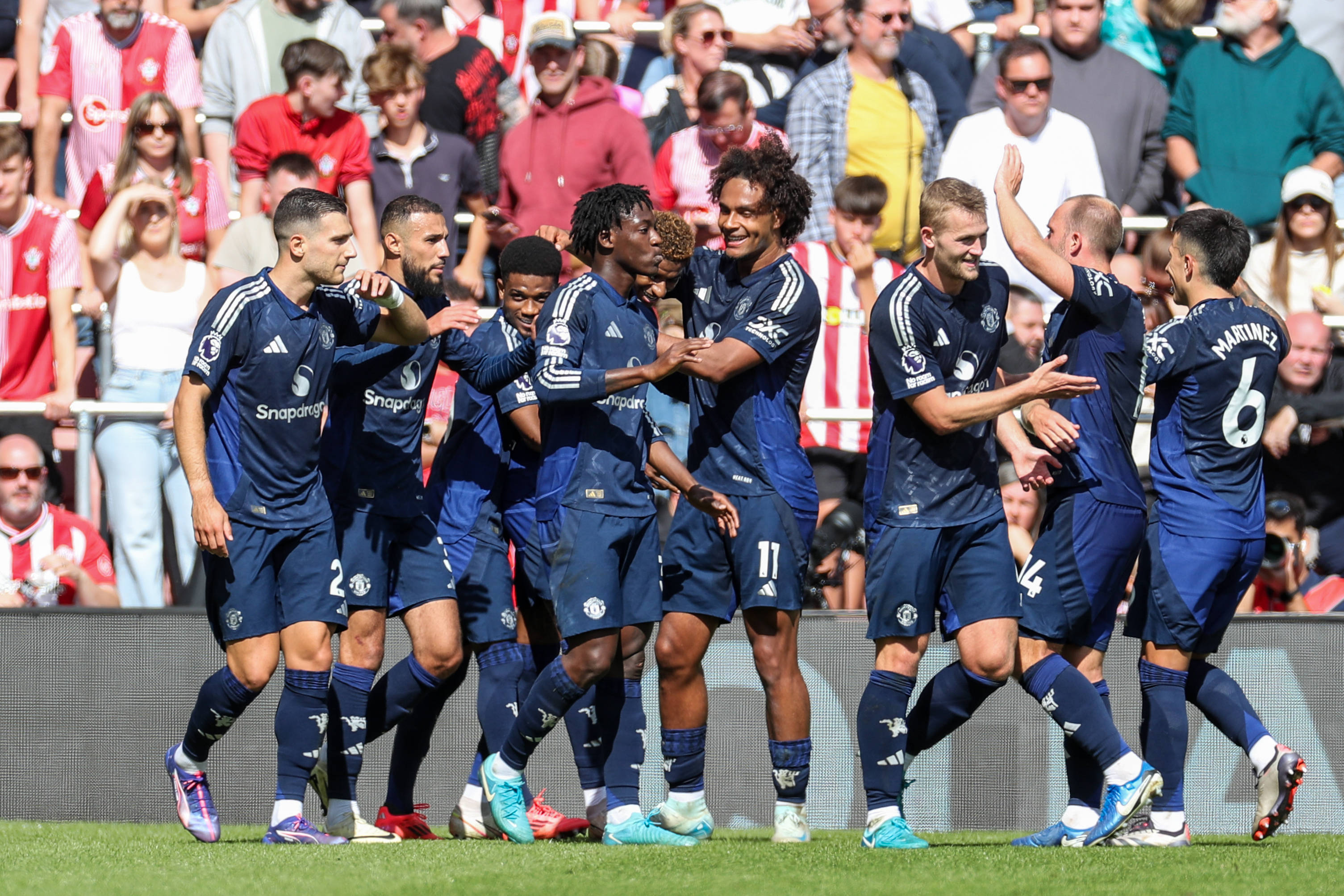 Amad celebrates with Manchester United teammates