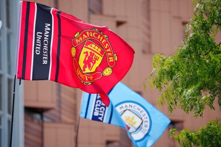 Manchester United and Manchester City flags