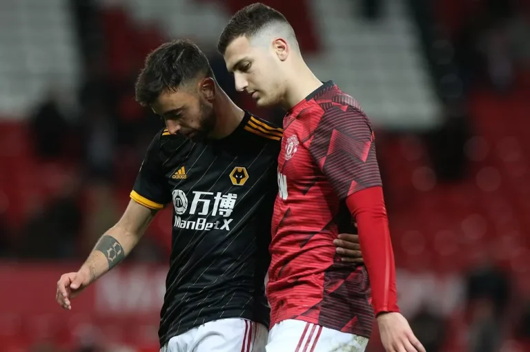 Bruno Fernandes and Diogo Dalot sad