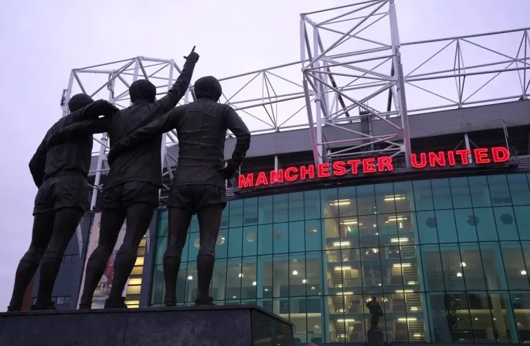 Old Trafford and the Manchester United trinity statue