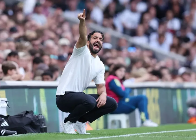 Ruben Amorim crouching at Fulham vs Manchester United at Craven Cottage
